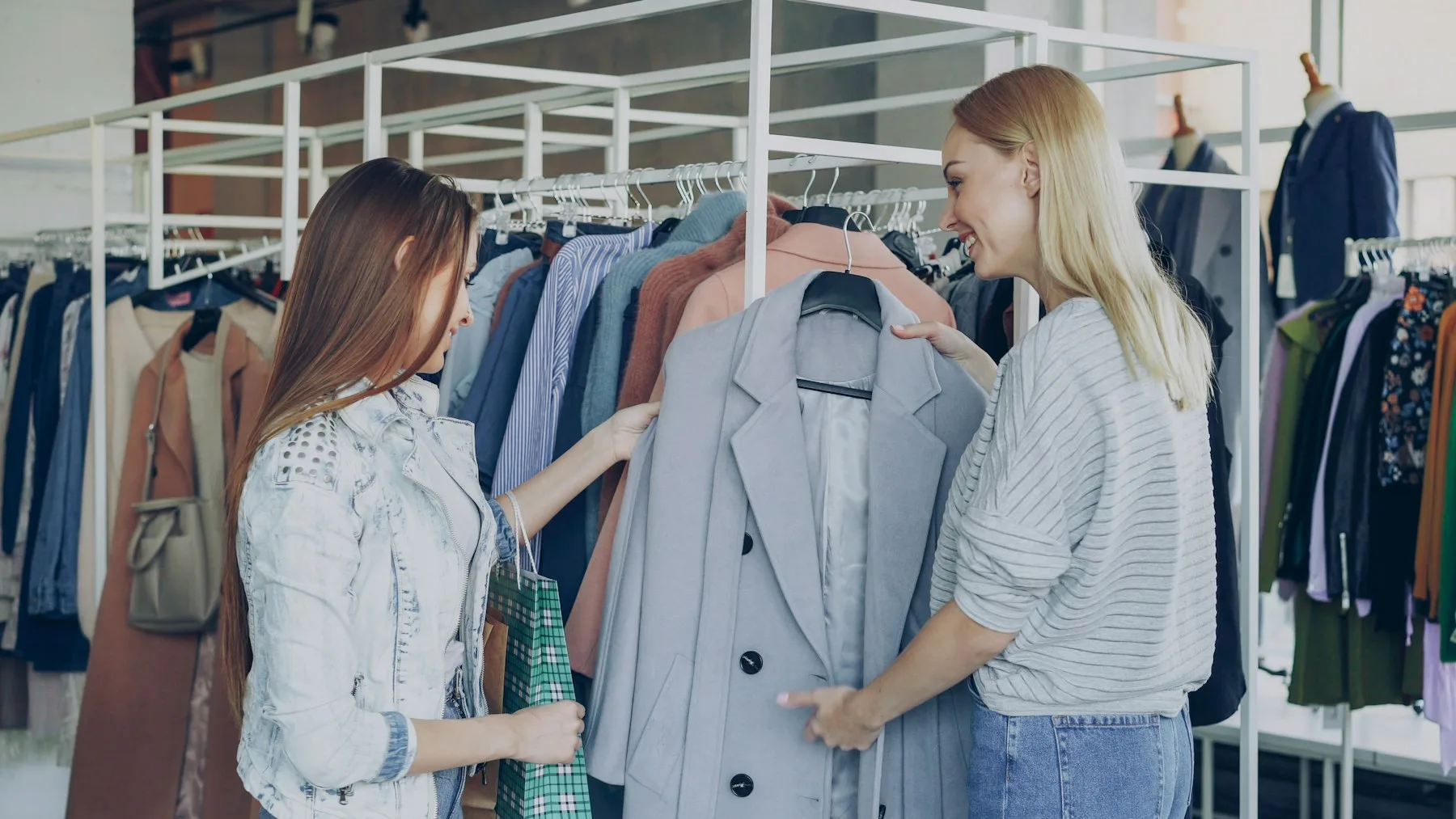 Shop assistant helping a customer choose clothing